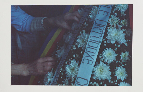 Analog photo of a woman arranging a funeral flower decoration