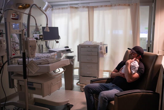 Father and infant in NICU
