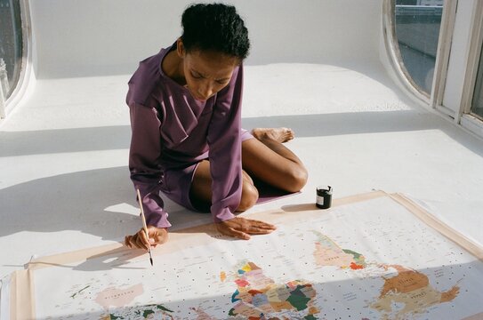 Woman notes dots on the world map