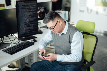 Portrait of Chinese male engineer with computer in office