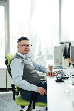 Portrait of Chinese male engineer with computer in office