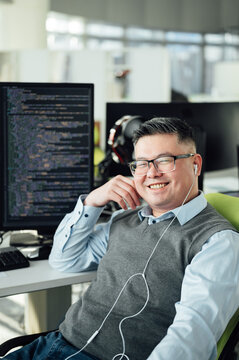 Portrait of Chinese male engineer with computer in office