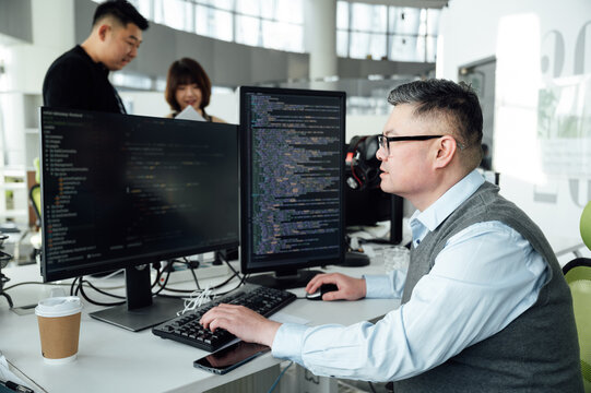 Portrait of Chinese male engineer with computer in office