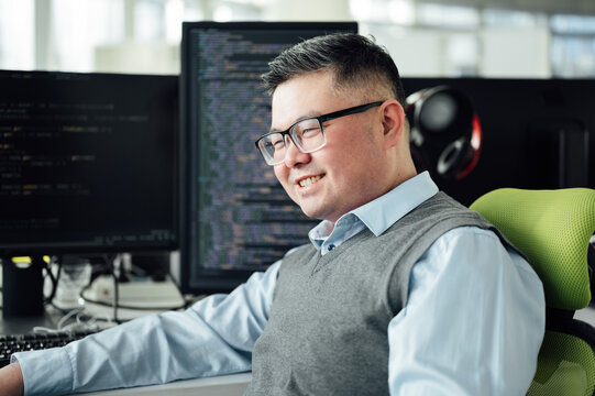Portrait of Chinese male engineer with computer in office