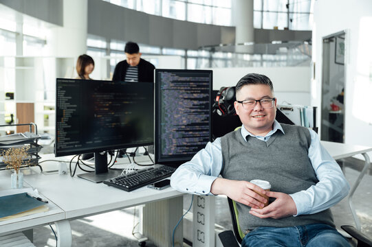 Portrait of Chinese male engineer with computer in office