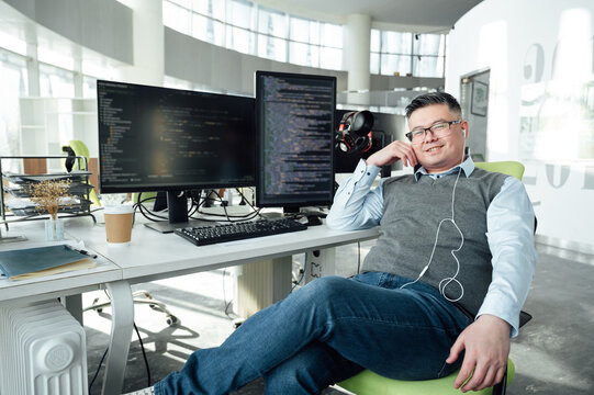 Portrait of Chinese male engineer with computer in office