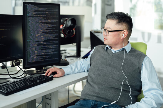 Portrait of Chinese male engineer with computer in office