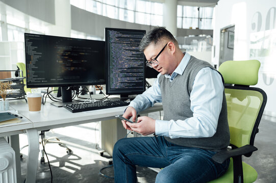 Portrait of Chinese male engineer with computer in office