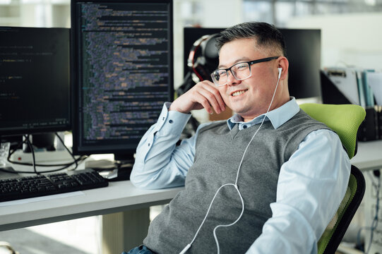 Portrait of Chinese male engineer with computer in office