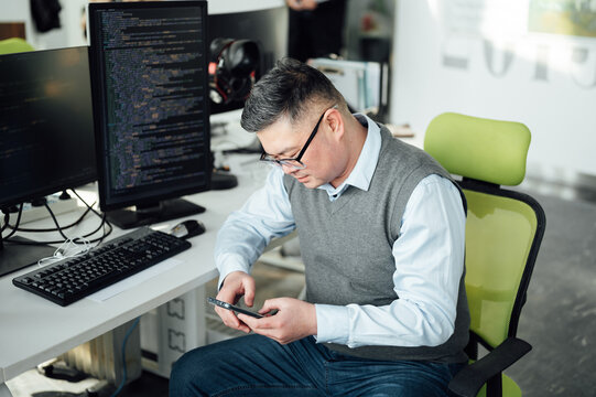 Portrait of Chinese male engineer with computer in office