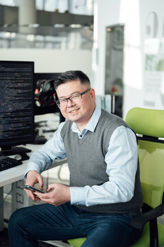 Portrait of Chinese male engineer with computer in office