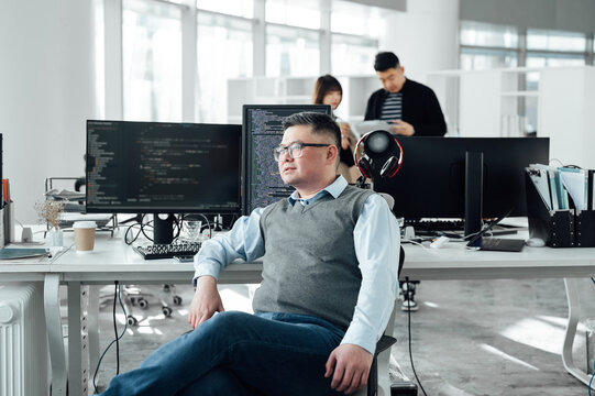 Portrait of Chinese male engineer with computer in office