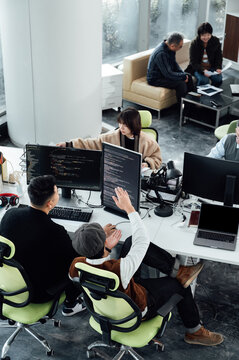 Casual Business People Working On Computers In Open Plan Office