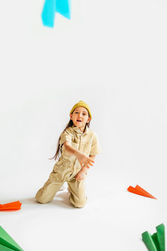 Little Girl Playing with Paper Airplanes 
