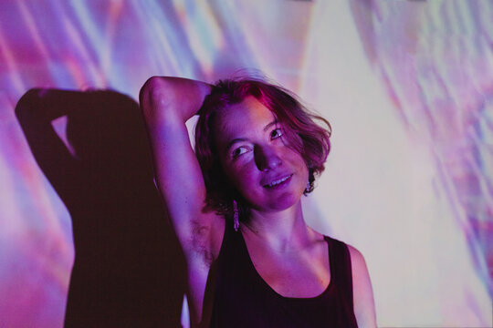 Happy woman with armpit hair