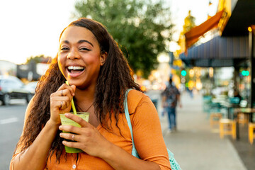 Woman Drinks Green Juice Outside