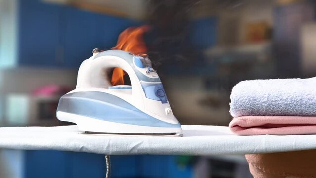Home appliance fire due to malfunction or overheating, electric ironing iron caught fire in living room.