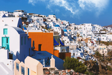 Traditional greek white houses on Santorini coast near the Aegean Sea. Village on the cliff under...