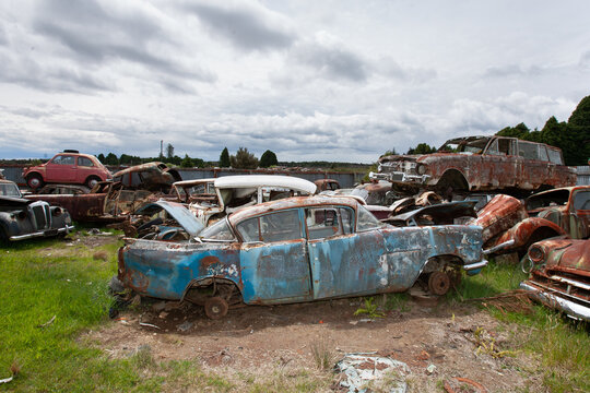 Ruined classic cars at a dumping yard