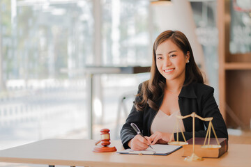 Lawyer's Office. Scales and hammer Asian female lawyer working with legal documents, advice and...