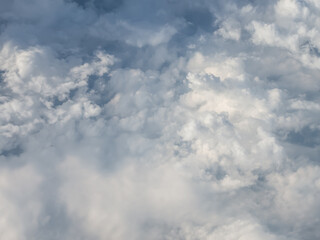 Beautiful Nimbo clouds view by looking through an airplane window.