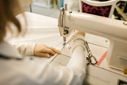 Anonymous Woman Using A Sewing Machine