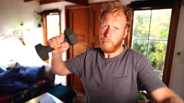 Working out at home, doing a home workout with weights, punching towards camera