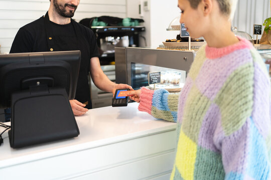 Woman paying consumption  with credit card