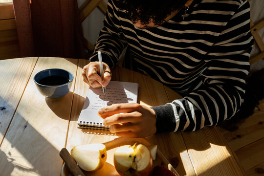 close up of man writing on notebook