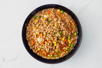 healthy plant-based food, vegan barley minestrone soup with peas carrots and corn in savoury broth