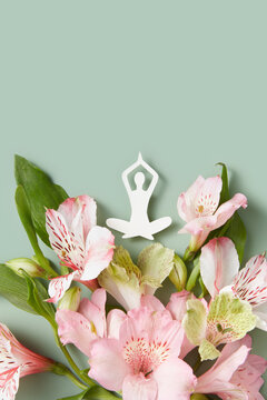 Handmade meditating woman on spring flowers