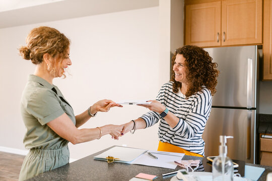 Realtor formalizing home sale from kitchen