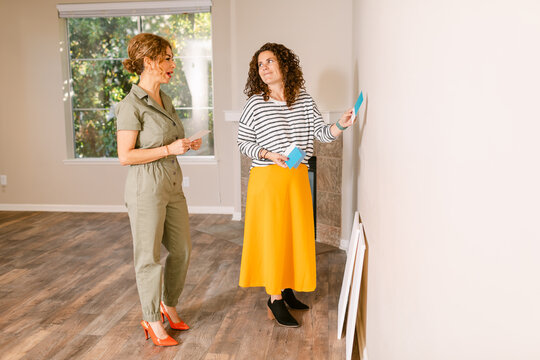 Owner with designer choosing accent wall colors