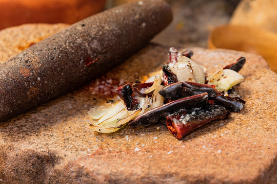 onion and chiles on a stone metate