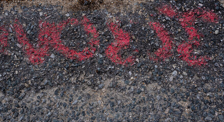 Red spray painted markings on pavement grunge texture