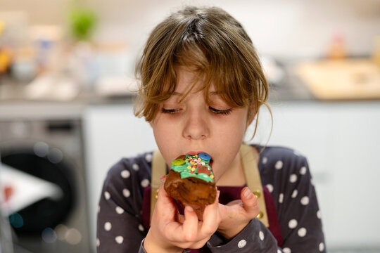 Girl eating dessert in kitchen