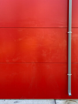red wall with drainpipe
