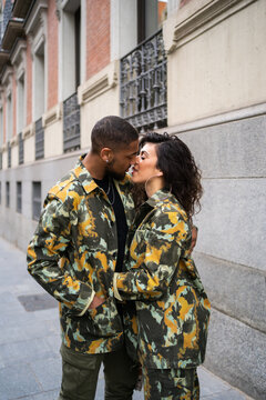 Mixed-Race Couple With Camouflage Fabric Clothes On the Street.