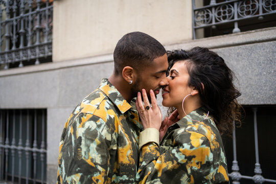 Mixed-Race Couple With Camouflage Fabric Clothes On the Street.