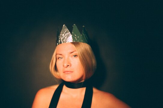A beautiful woman wears toy crown