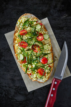 Pide with goat cheese, tomato and zucchini