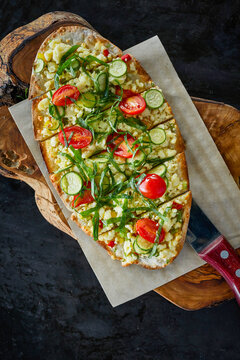 Pide with goat cheese, tomato and zucchini