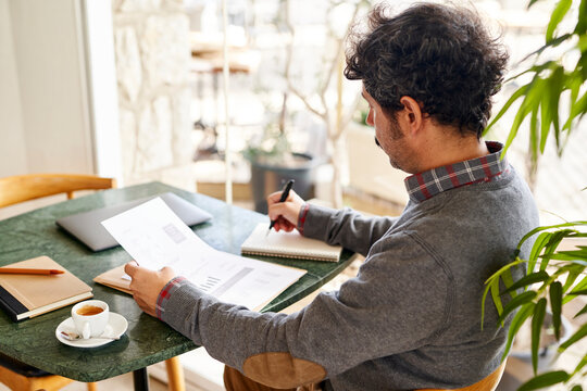 Businessman doing paperwork and taking notes