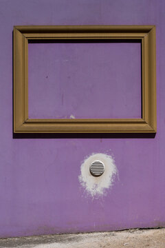 Golden frame on purple wall