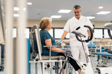 Doctor helping woman during rehabilitation training