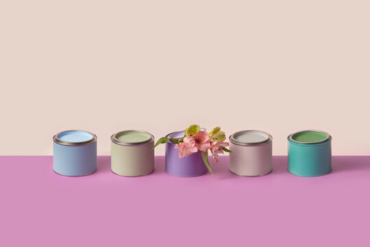 Colored tins cans with flowers over duotone background