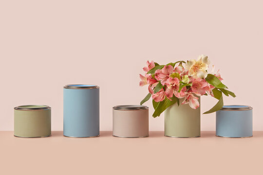 Various tins of pastel paints with spring flowers