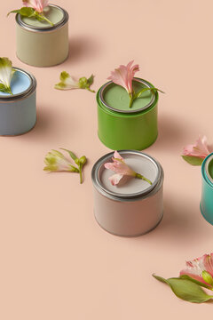 Spring flowers lying on tins of pastel paints