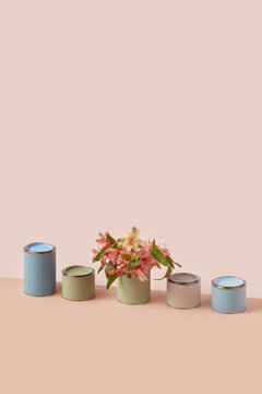 Fresh spring flowers placed inside paint tin cans