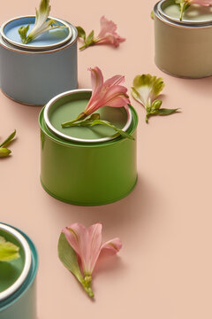 Various tin cans of paint decorated with spring flowers